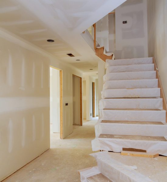 Interior new home construction of housing project with drywall installed New home interior construction of housing with drywall installed
